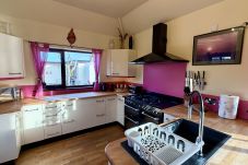 Fully equipped modern kitchen with range cooker and breakfast bar at Pheasants Haunt in Paignton